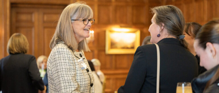 Two women talking at the QueensCare Annual Scholarship Luncheon